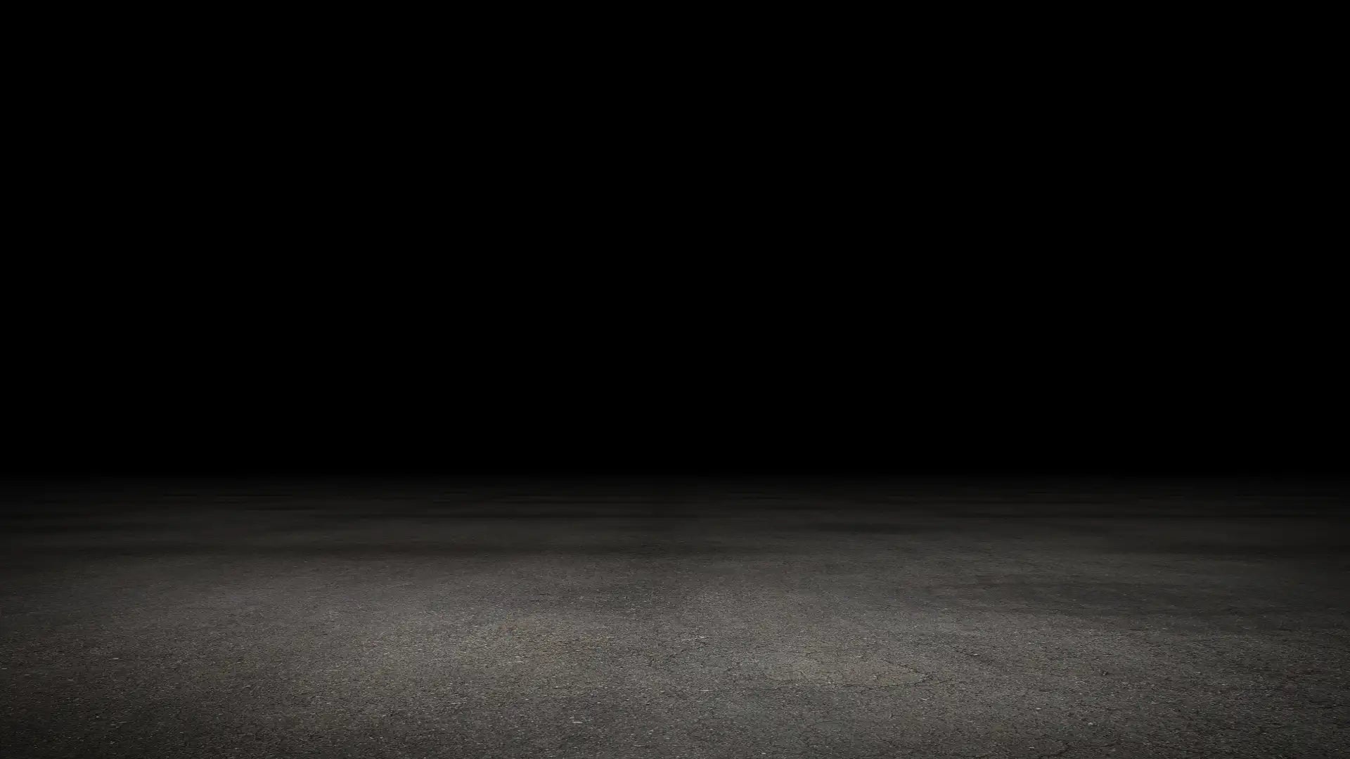 Dunkelgrauer Betonboden mit glatter, leicht texturierter Oberfläche.